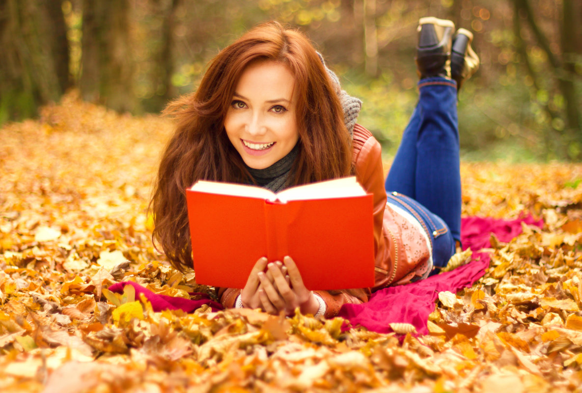 Happy young woman with book - Мирослава Струк