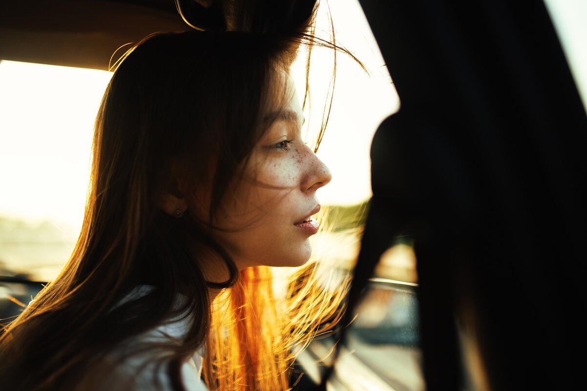 Портрет девушки с веснушками, выглядывающей в окно машины во время сильного ветра - Lenar Abdrakhmanov