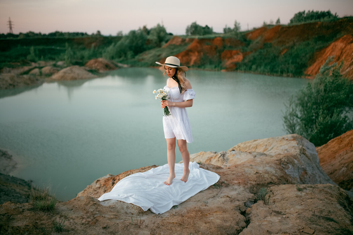 Девушка в легком белом платье гуляет по берегу песчаного карьера на рассвете - Lenar Abdrakhmanov