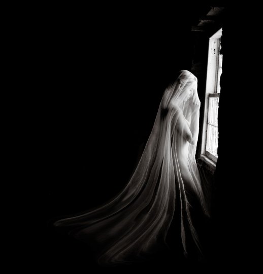 Женщина в вуали у окна.